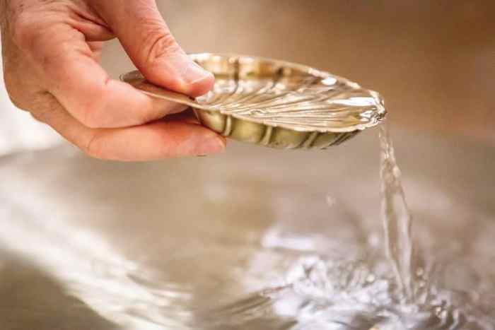 What does the holy water symbolize for father paul